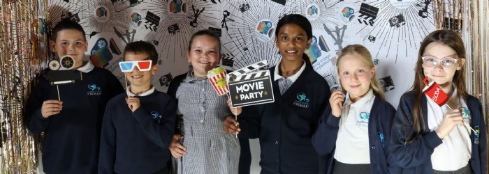 Students posing with props from the photo booth